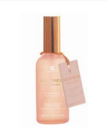 A light pink glass bottle of calming de stress room spray