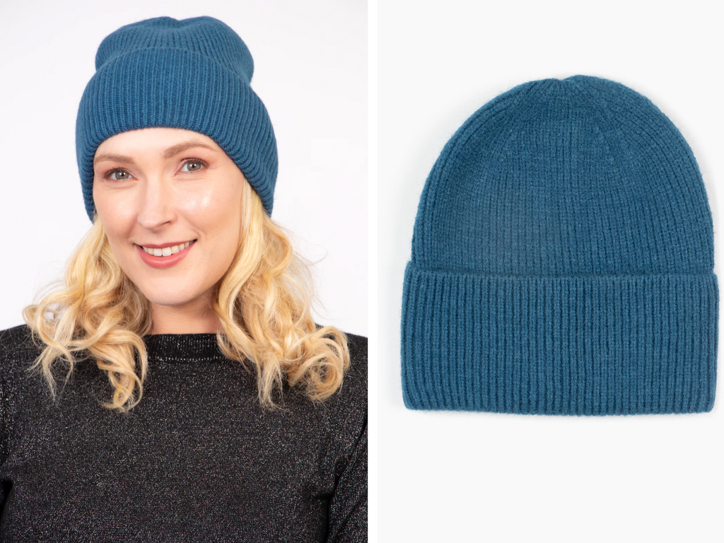 model wearing a teal beanie hat in soft acrylic 