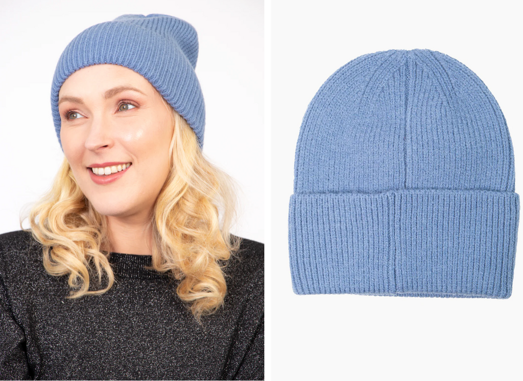 model wearing a plain denim blue beanie hat in a soft acrylic 