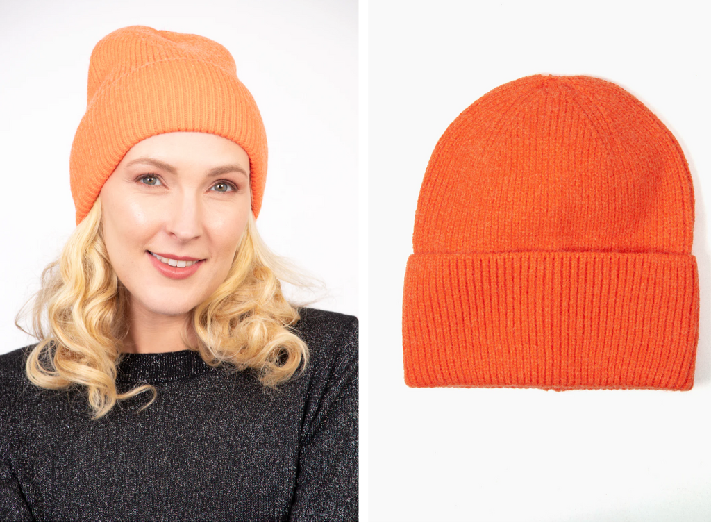 model wearing orange plain beanie hat in soft acrylic 